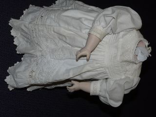 Puppenkleidung Einer Porzellanpuppe Mit Defektem Kopf,  Schuhe,  Unterwäsche Bild